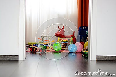 Childrenâ€™s multicolored toys on wooden floor or carpet on kids room Stock Photo